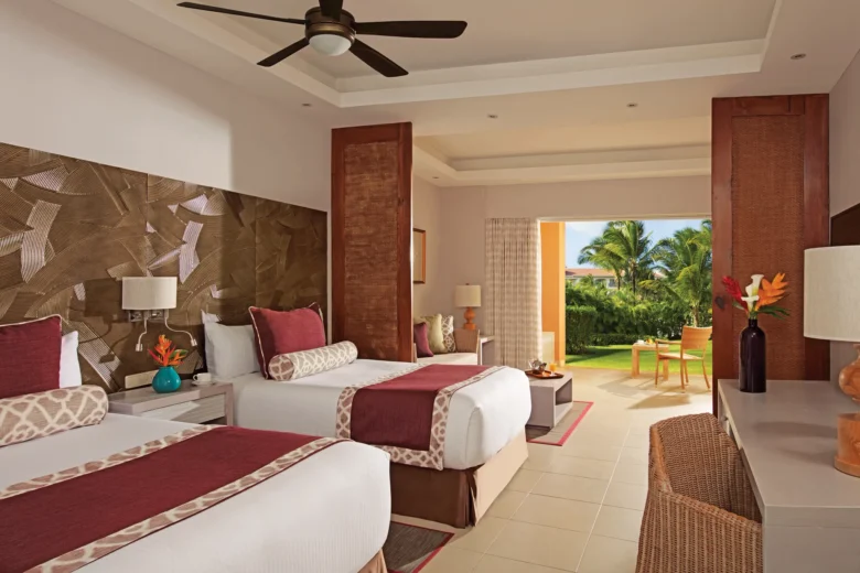 Deluxe Family Room Tropical View with two double beds, connecting space, and terrace at Dreams Royal Beach Punta Cana.