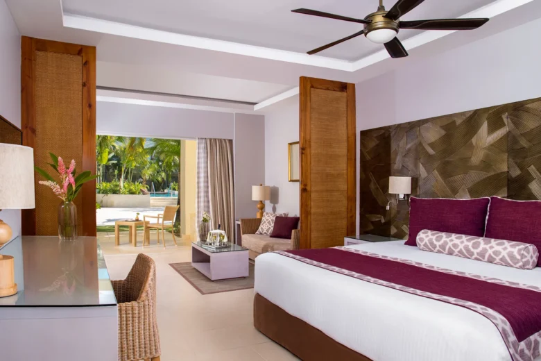 Deluxe Pool Terrace room with king bed, seating area, and terrace at Dreams Royal Beach Punta Cana.