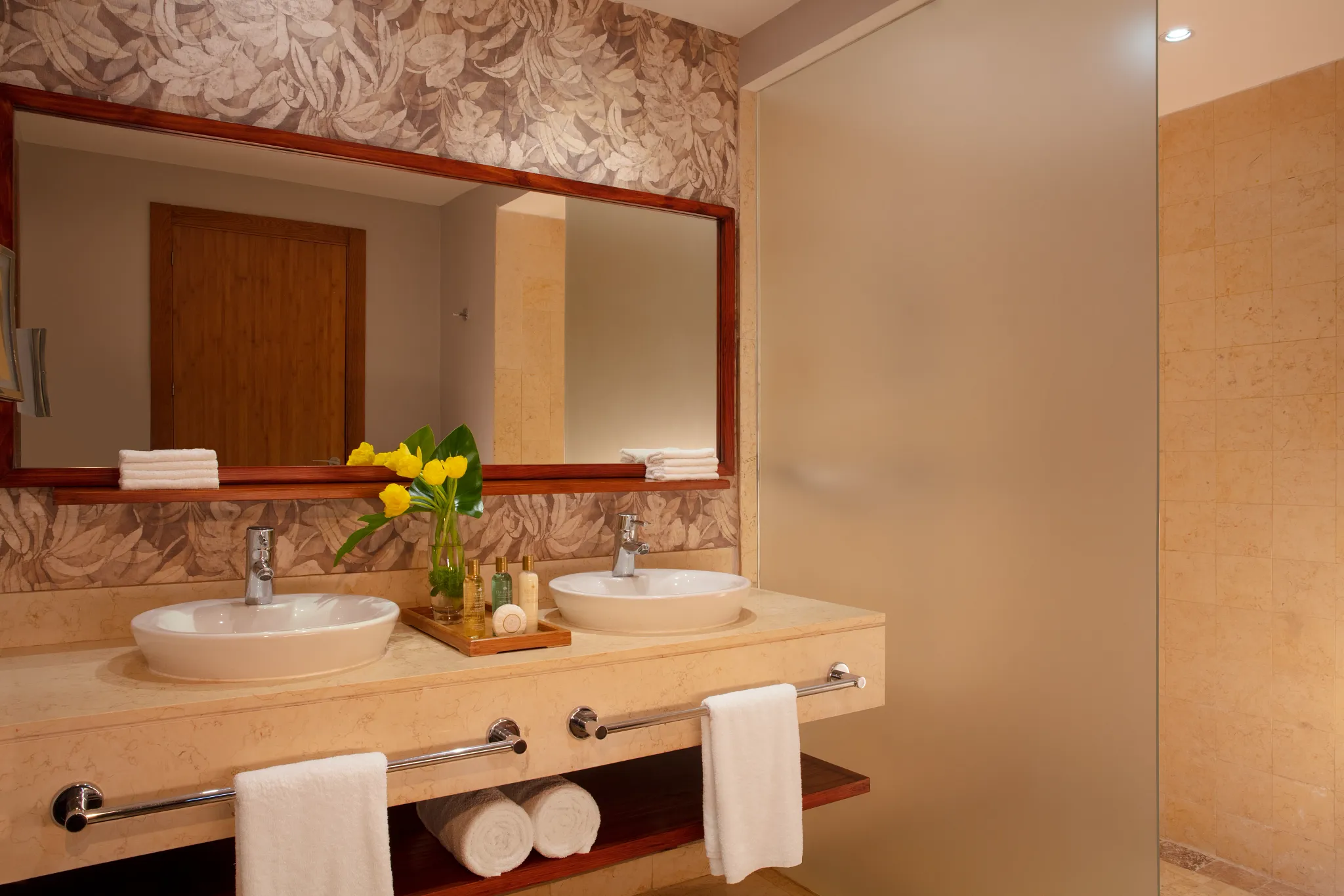 Deluxe Pool View bathroom with double sinks and walk-in shower at Dreams Royal Beach Punta Cana.