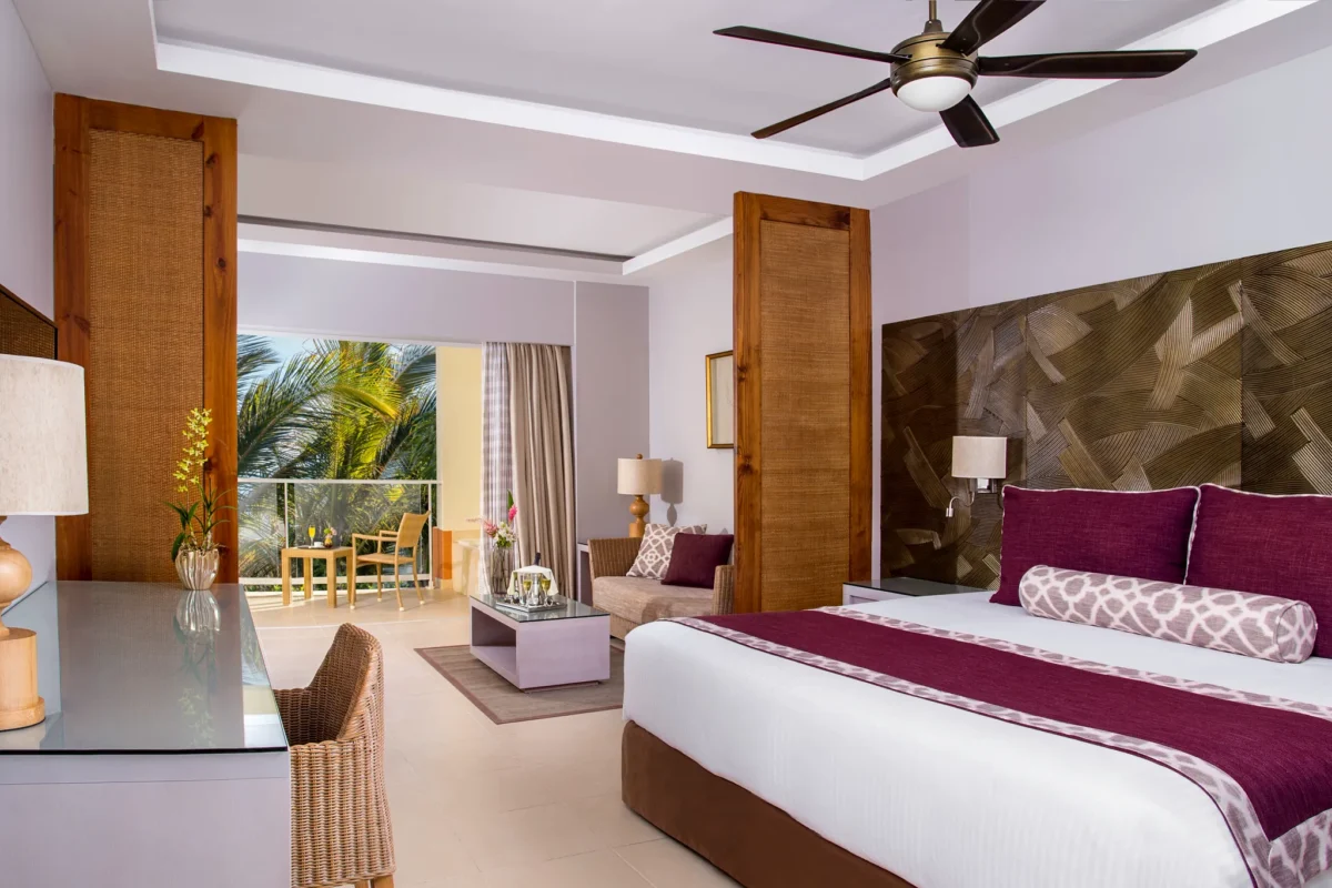 Deluxe Tropical View room with king bed, balcony, and seating area at Dreams Royal Beach Punta Cana.