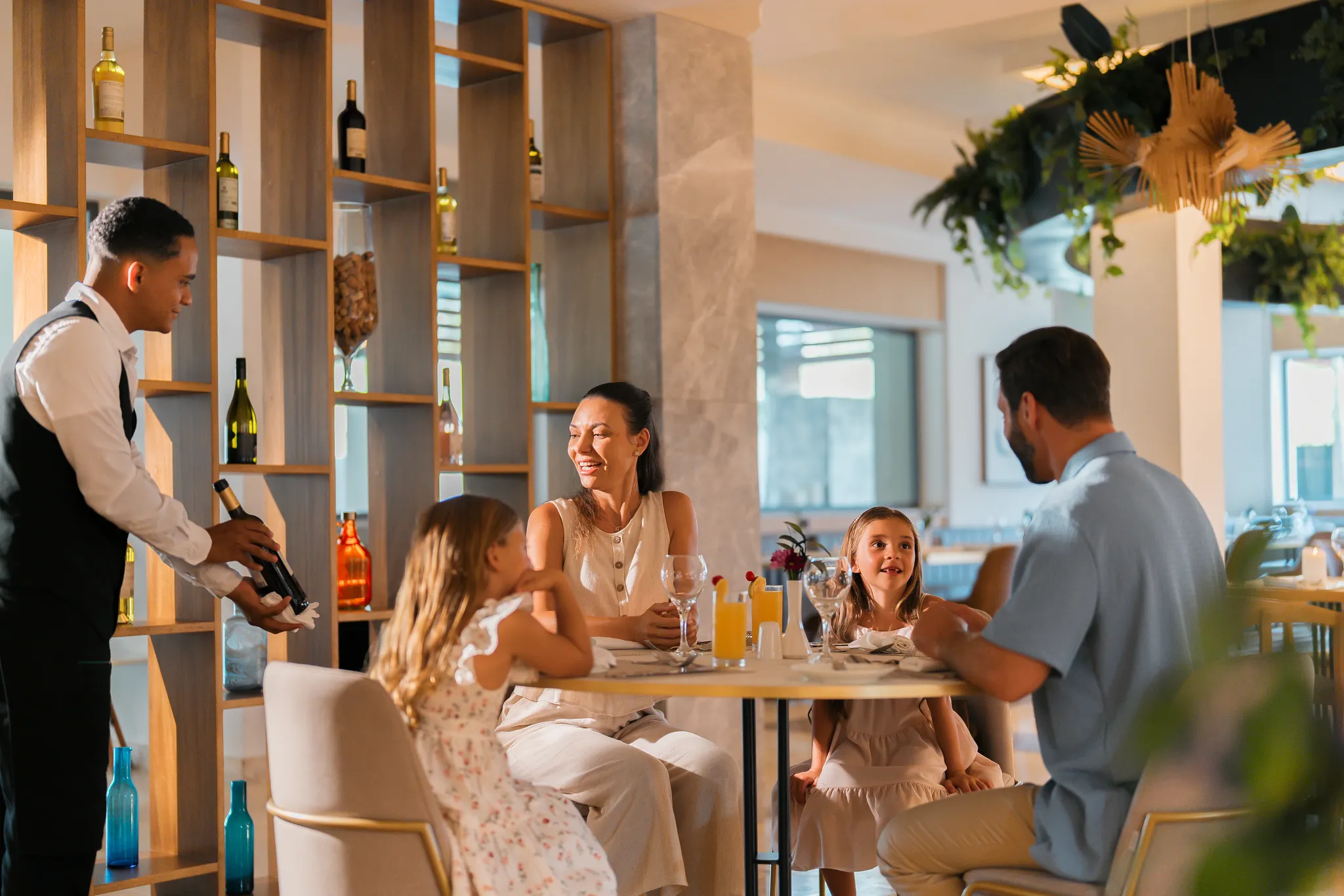 Family enjoying a relaxed dinner at a restaurant in Dreams Royal Beach Punta Cana with attentive service and a welcoming atmosphere.