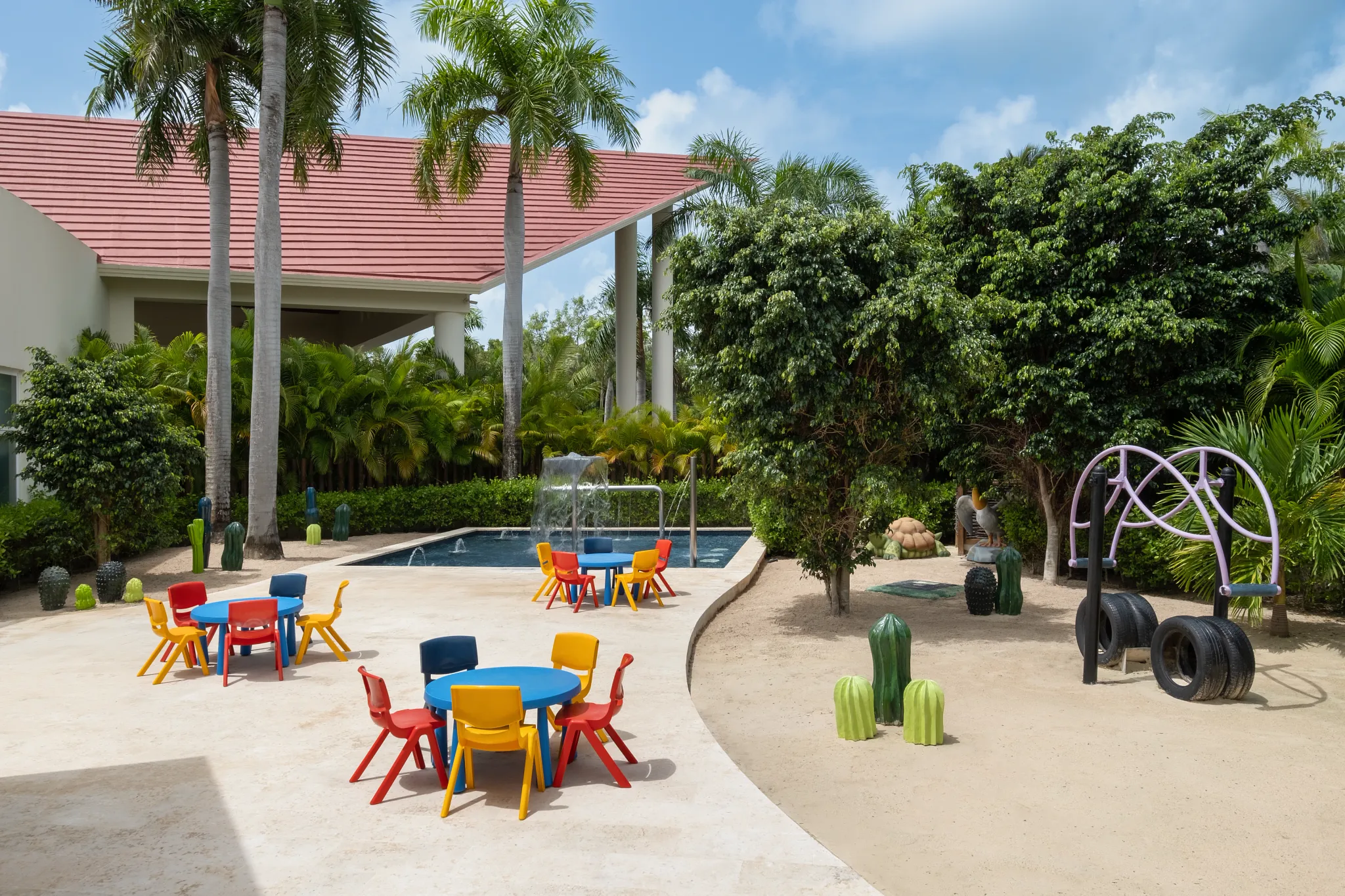 Outdoor kids club area with colorful tables and playground at Dreams Royal Beach Punta Cana.