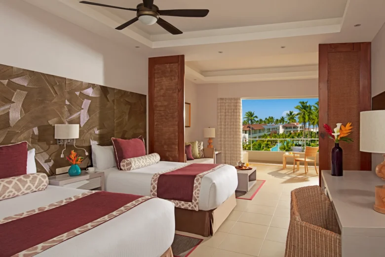 Preferred Club Deluxe Pool View room with two double beds and balcony overlooking pool at Dreams Royal Beach Punta Cana.