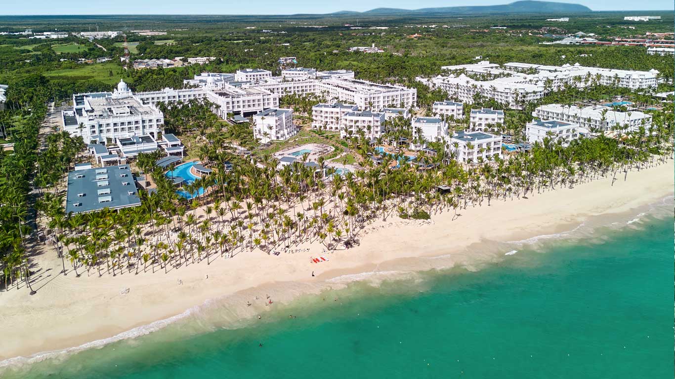 Riu Palace Bavaro all-inclusive resort in Punta Cana with expansive pools, beachfront location, and classic resort architecture.