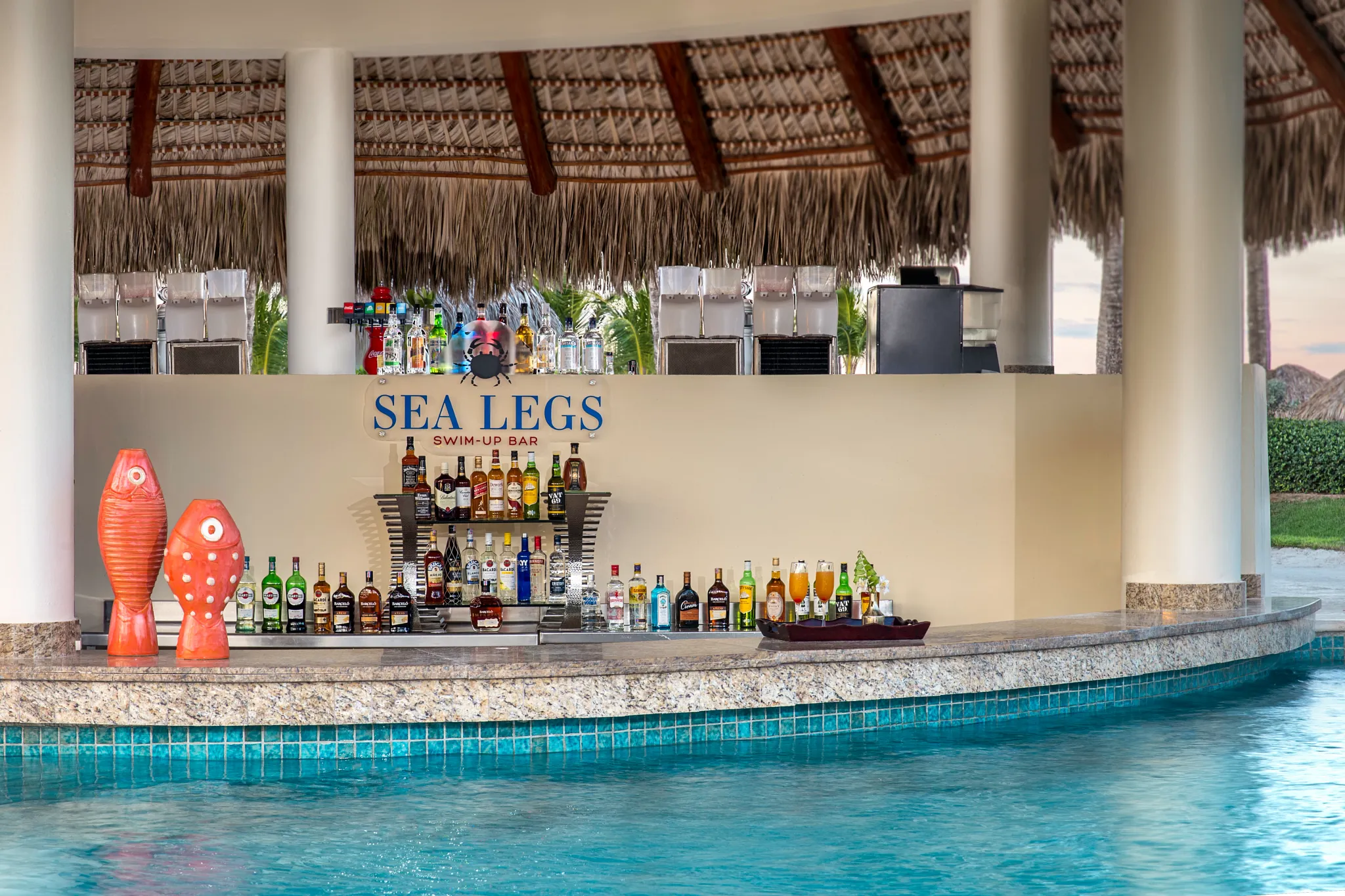 Sea Legs swim-up bar at Dreams Royal Beach Punta Cana featuring a tropical pool setting with refreshing cocktails and relaxed beach vibes.
