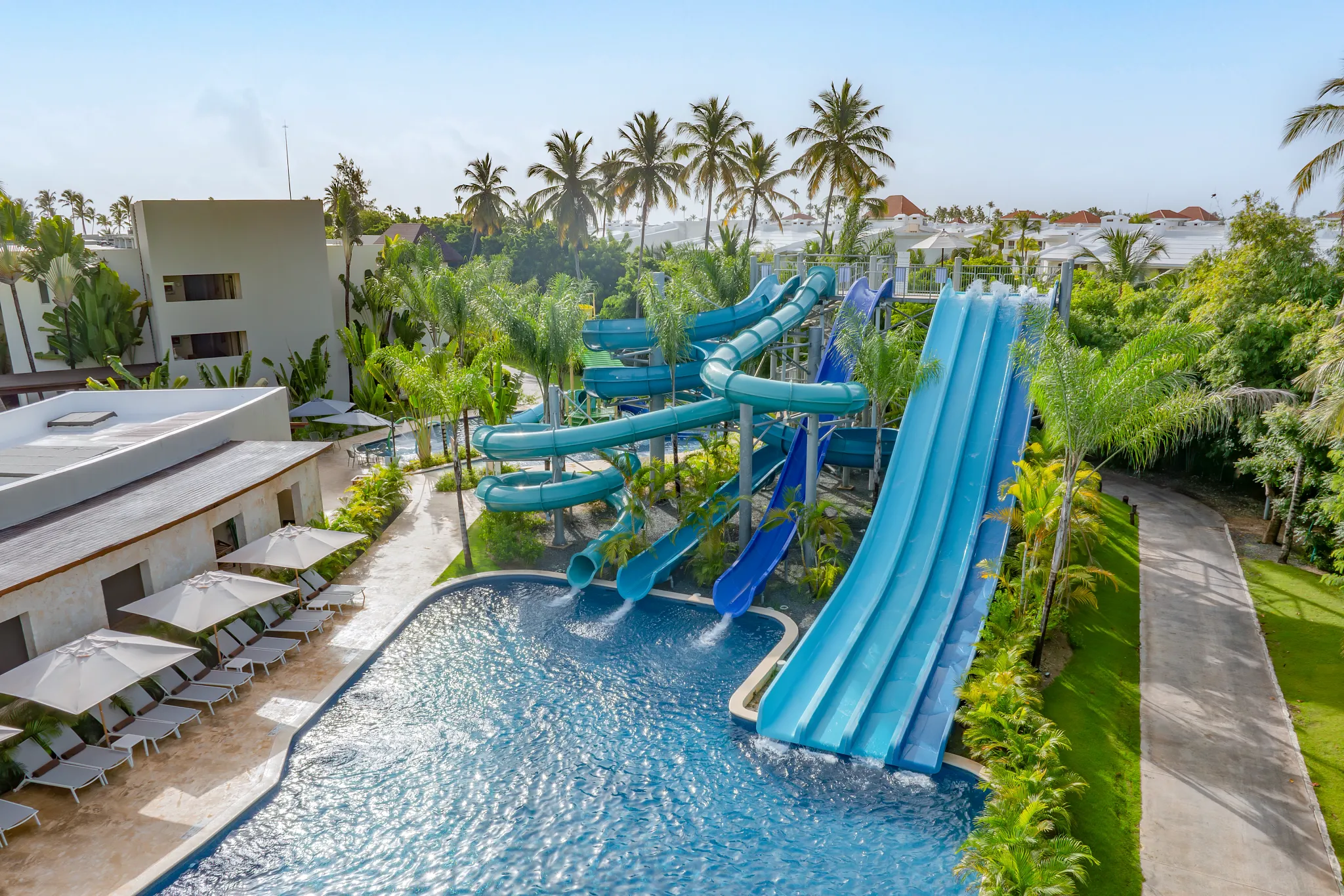 Large blue water slides and pool area at Dreams Royal Beach Punta Cana water park.